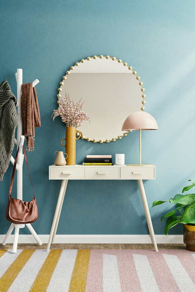 pastel colourway in modern entryway with retro design fixtures
